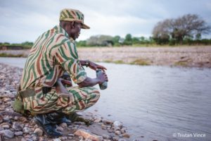 Image shows wildlife ranger out on patrol protecting rhino from poachers