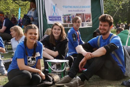 Three smiling events volunteer sitting down at the London Marathon picnic