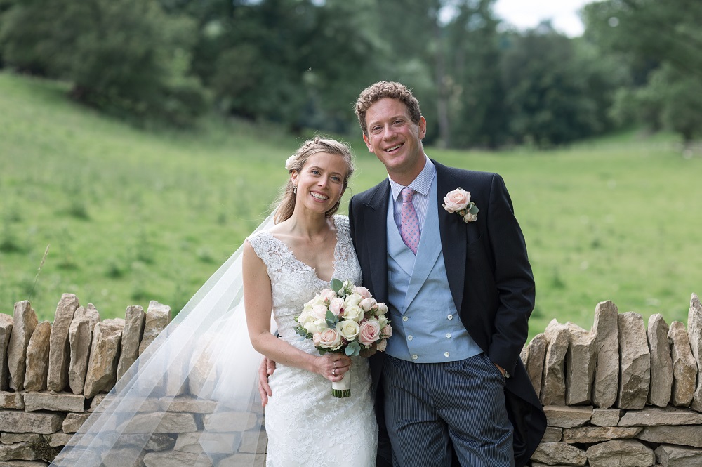 Smiling bride and groom in a feild