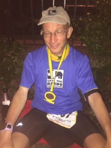 Image of Kenneth sitting with his medal after completing the GUCR.