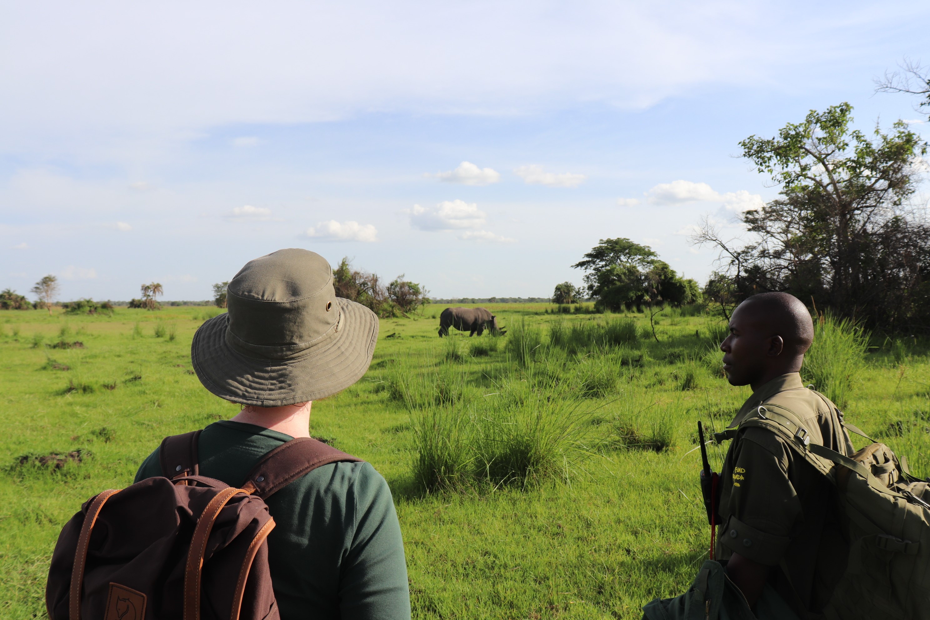 Wills and her ranger looking at rhinos at Ziwa