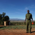 Borana gatehouse with ranger and view of Mt Kenya