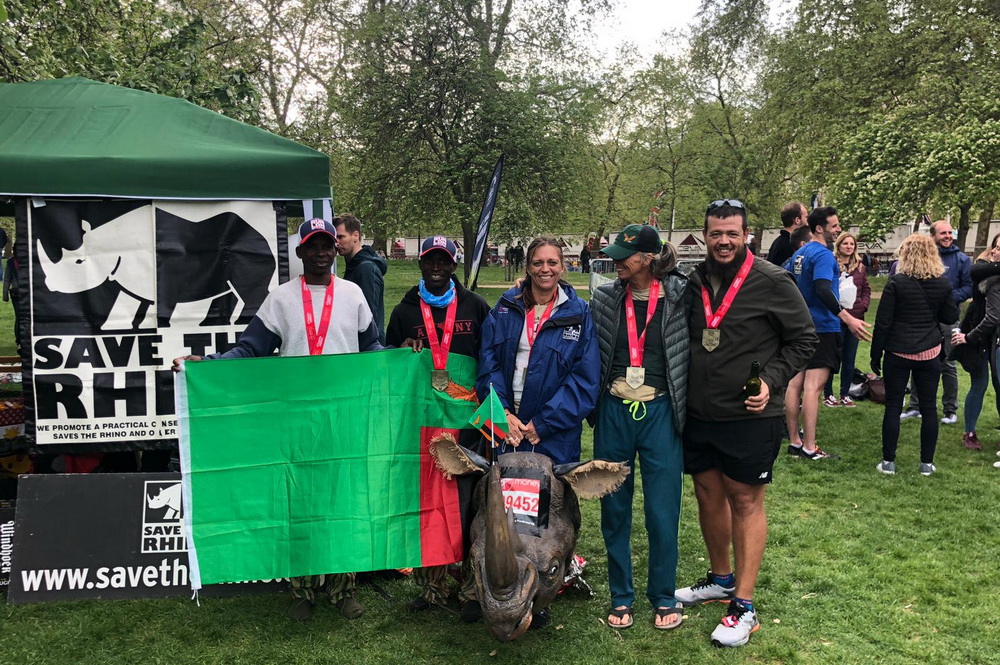 Image of the Zambia team with a Zambia flag after the marathon.