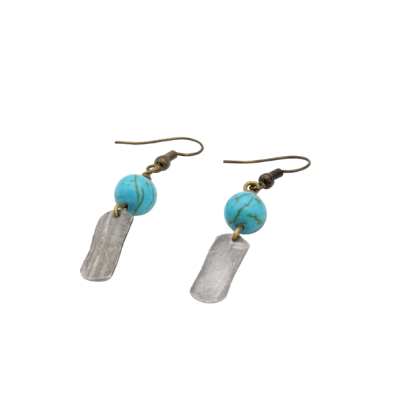 A photograph from the side of the Turquoise Snare Earrings