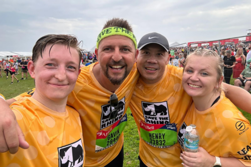 Four people in yellow t-shirts taking a selfie