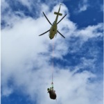 Black rhino hanging under helicopter