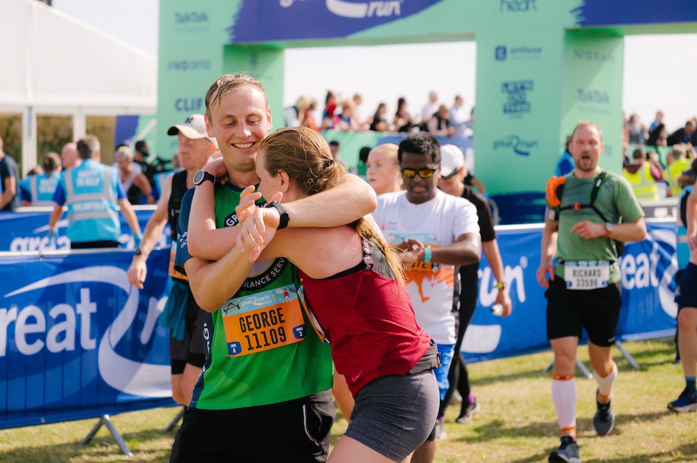 Runners embracing at the finish line