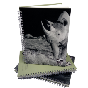 night time rhino notebook on stack of notebooks