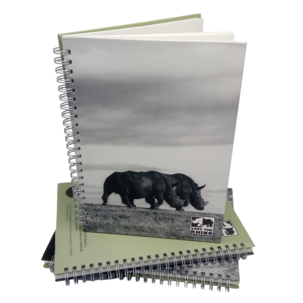 walking rhinos members' notebook on a stack of notebooks