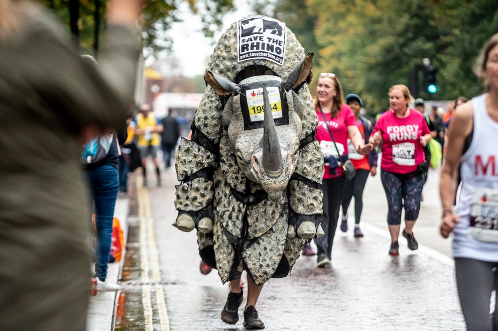 A person running in rhino costume during the Royal Parks Half.