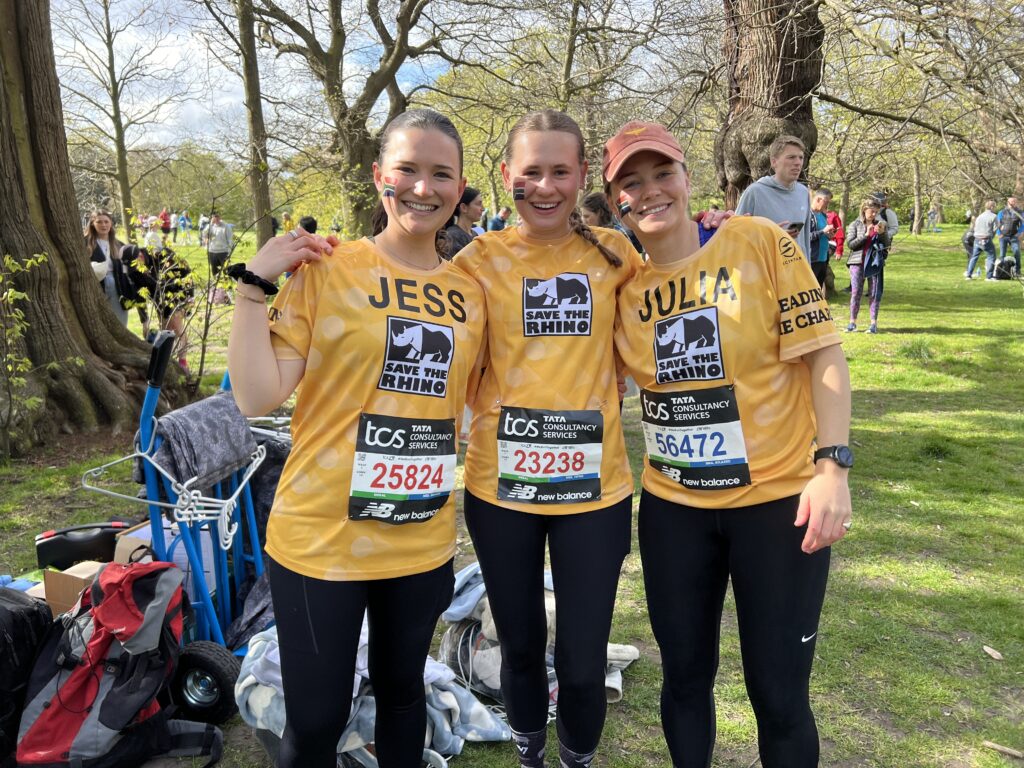 Three people smiling in yellow t-shirts from our Royal Parks Half team