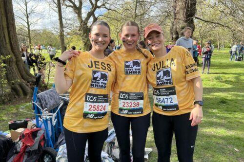 Three people smiling in yellow t-shirts from our Royal Parks Half team