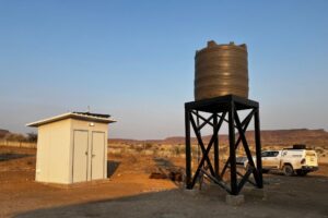 A latrine block and elevated water tank.