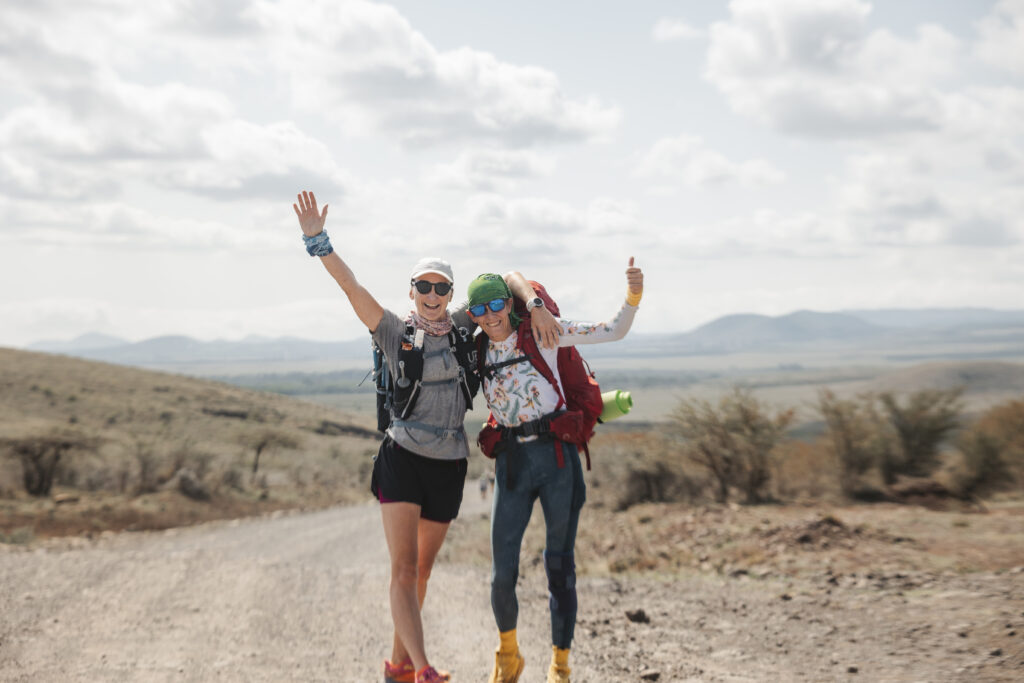 Two runners smiling on day one of the ultra, en route from Lewa to Borana Wildlife Conservancy
